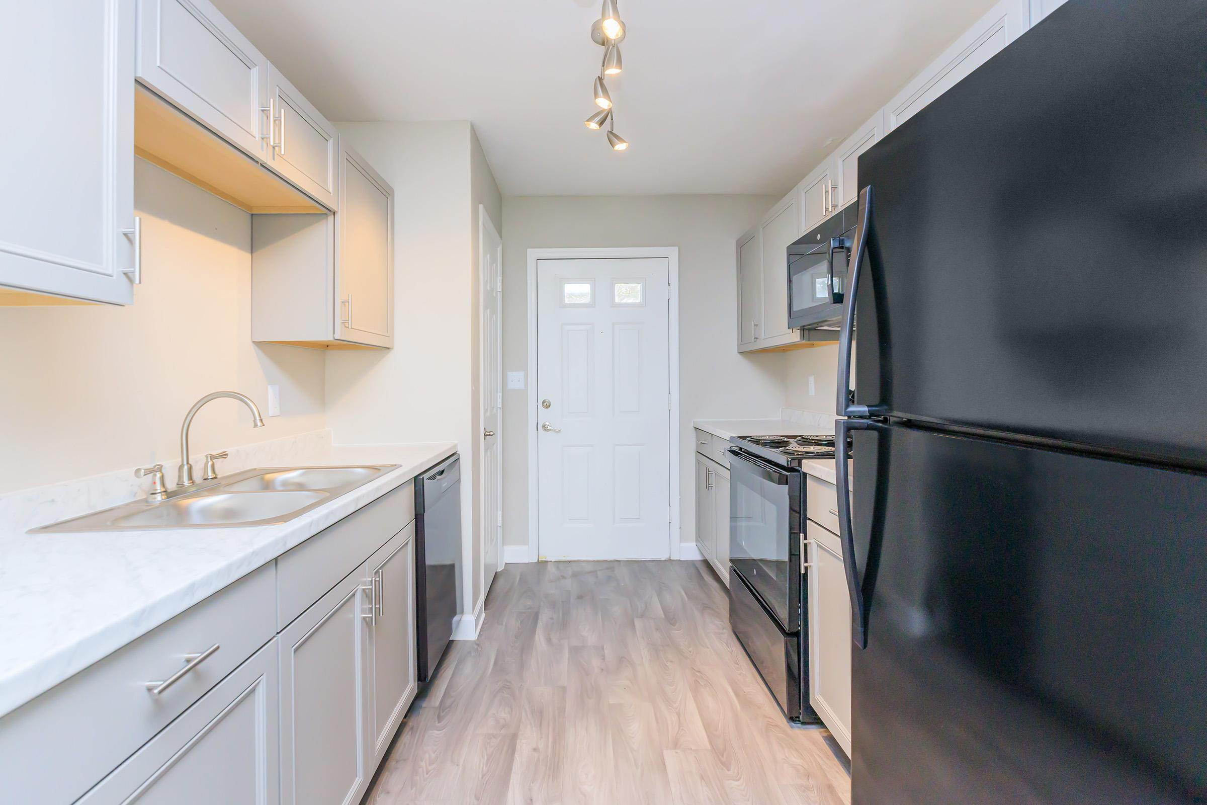 a kitchen with a sink and a refrigerator