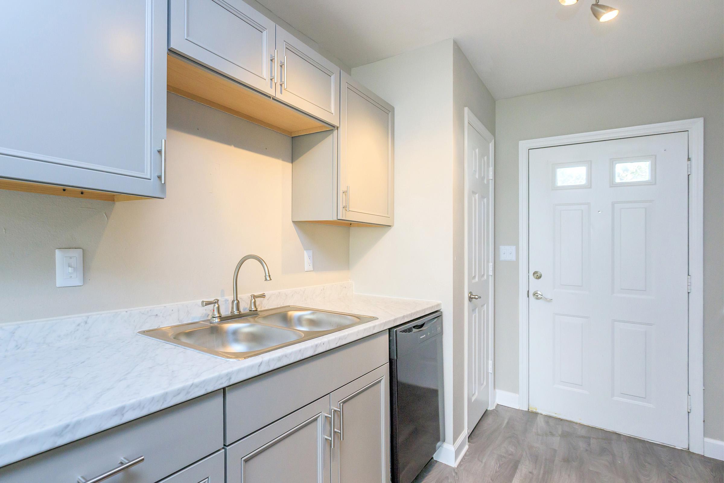 a kitchen with a sink and a mirror