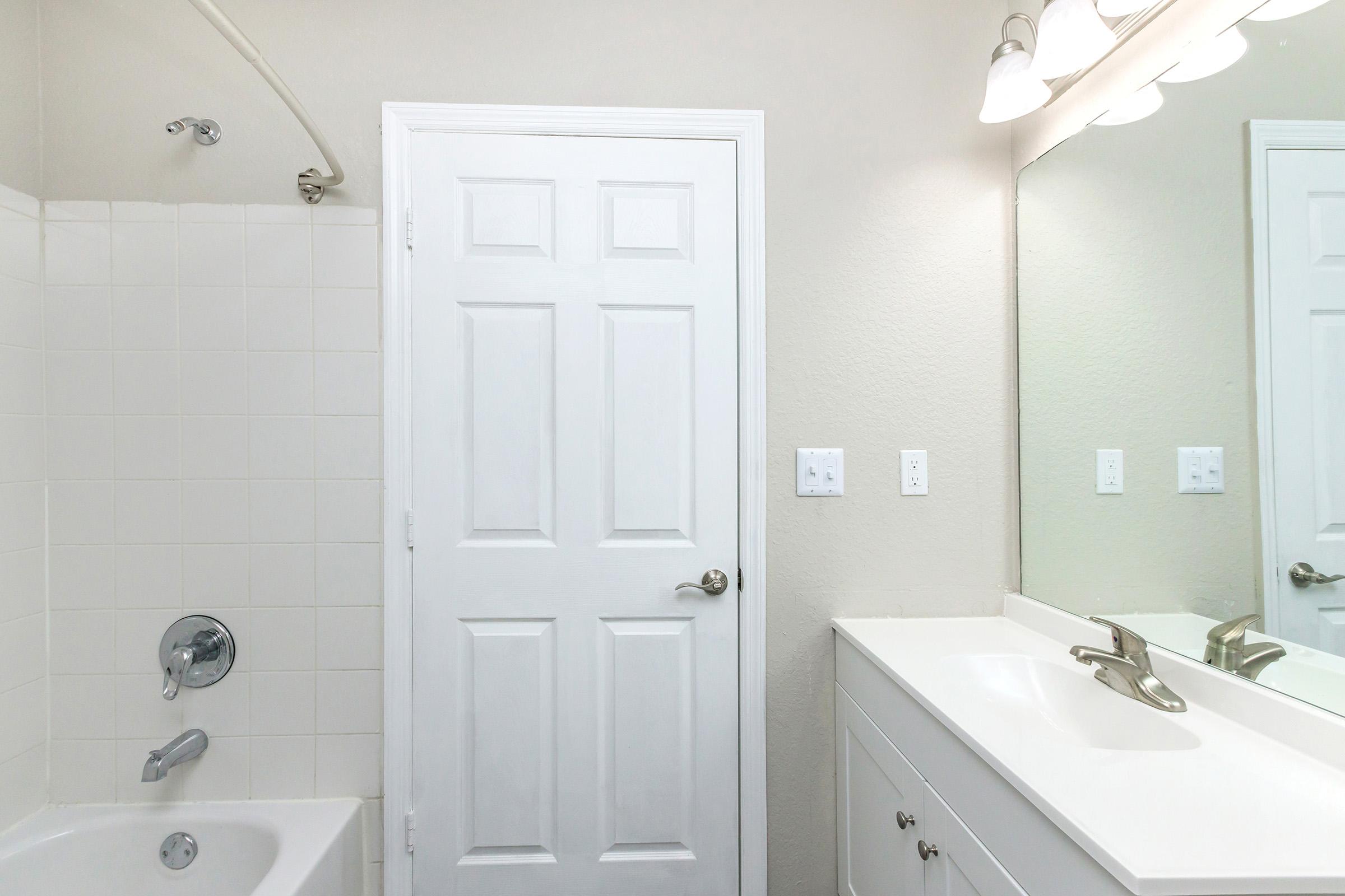 a room with a sink and a mirror