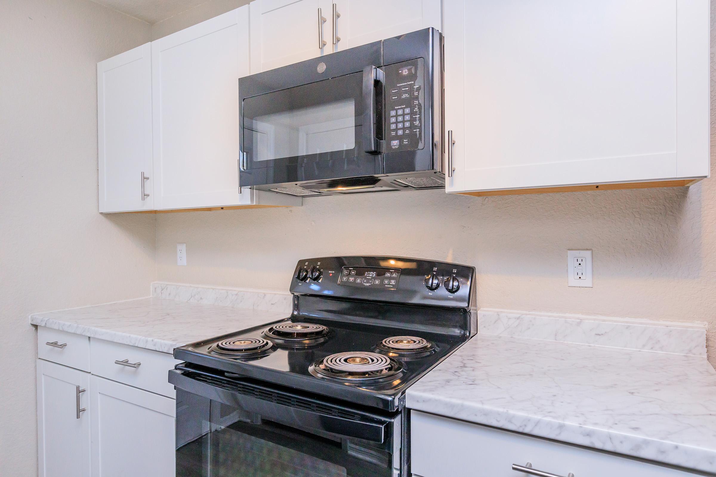 a stove top oven sitting inside of a kitchen