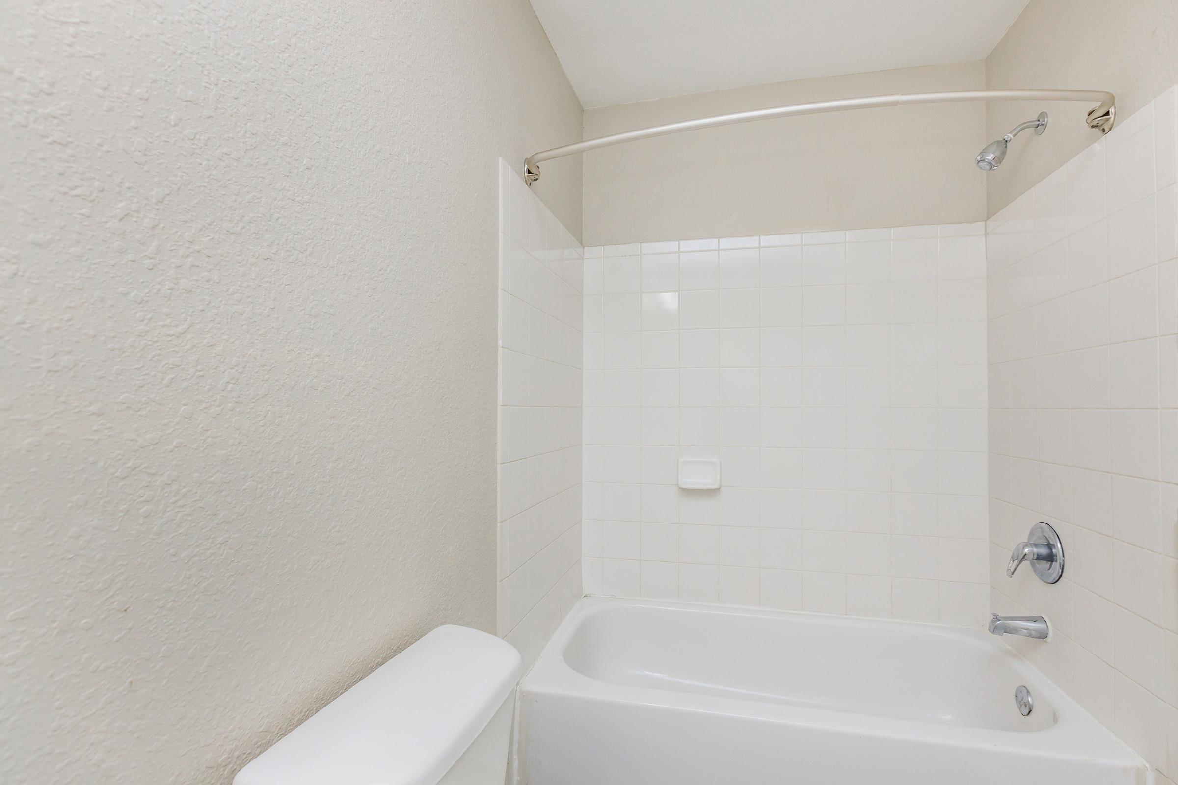 a sink and a white tub sitting next to a shower