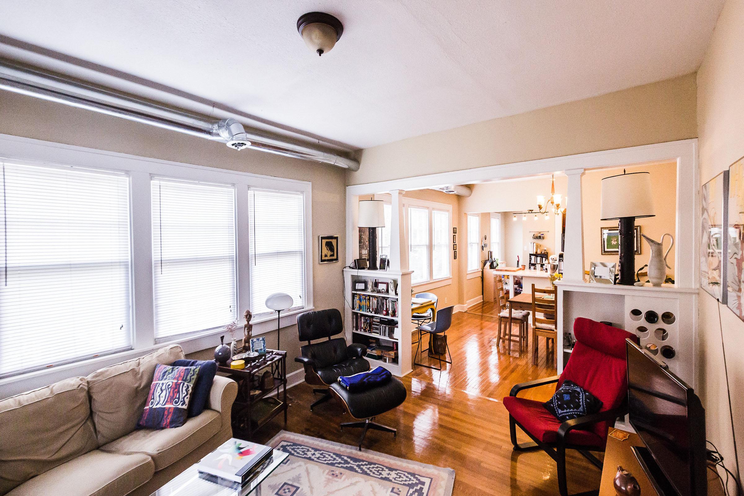 a living room filled with furniture and a large window