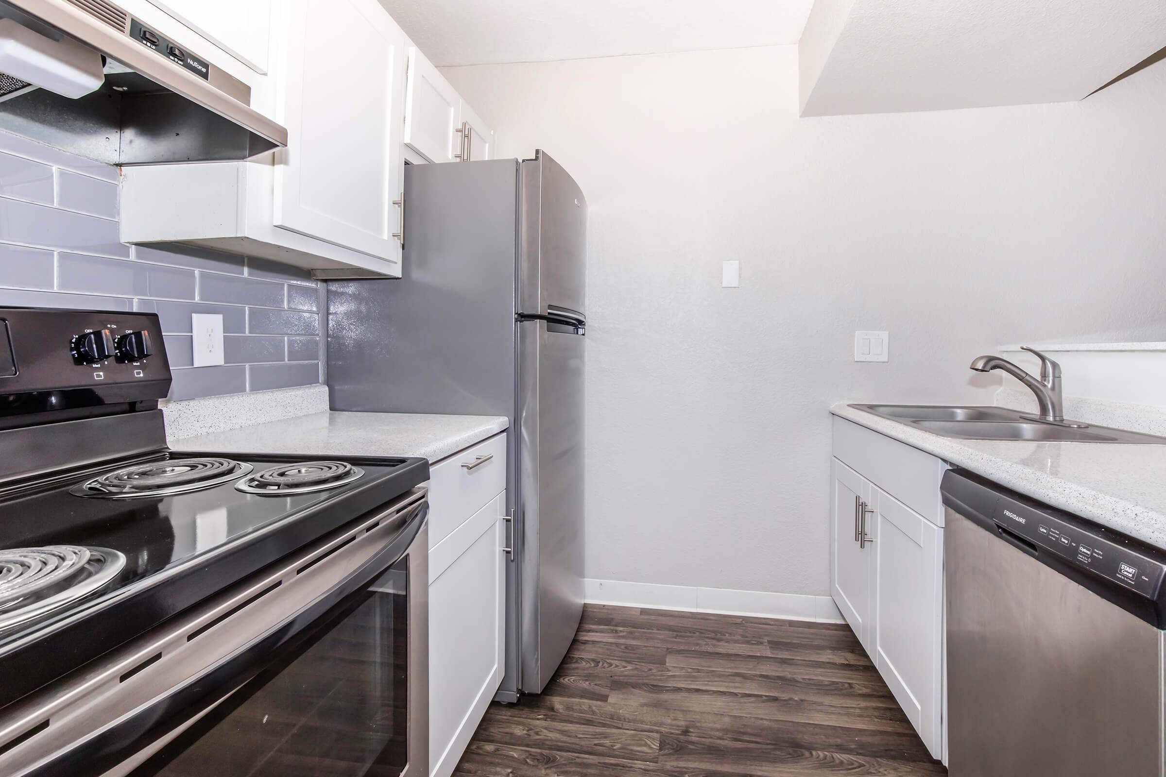 a stove top oven sitting inside of a kitchen