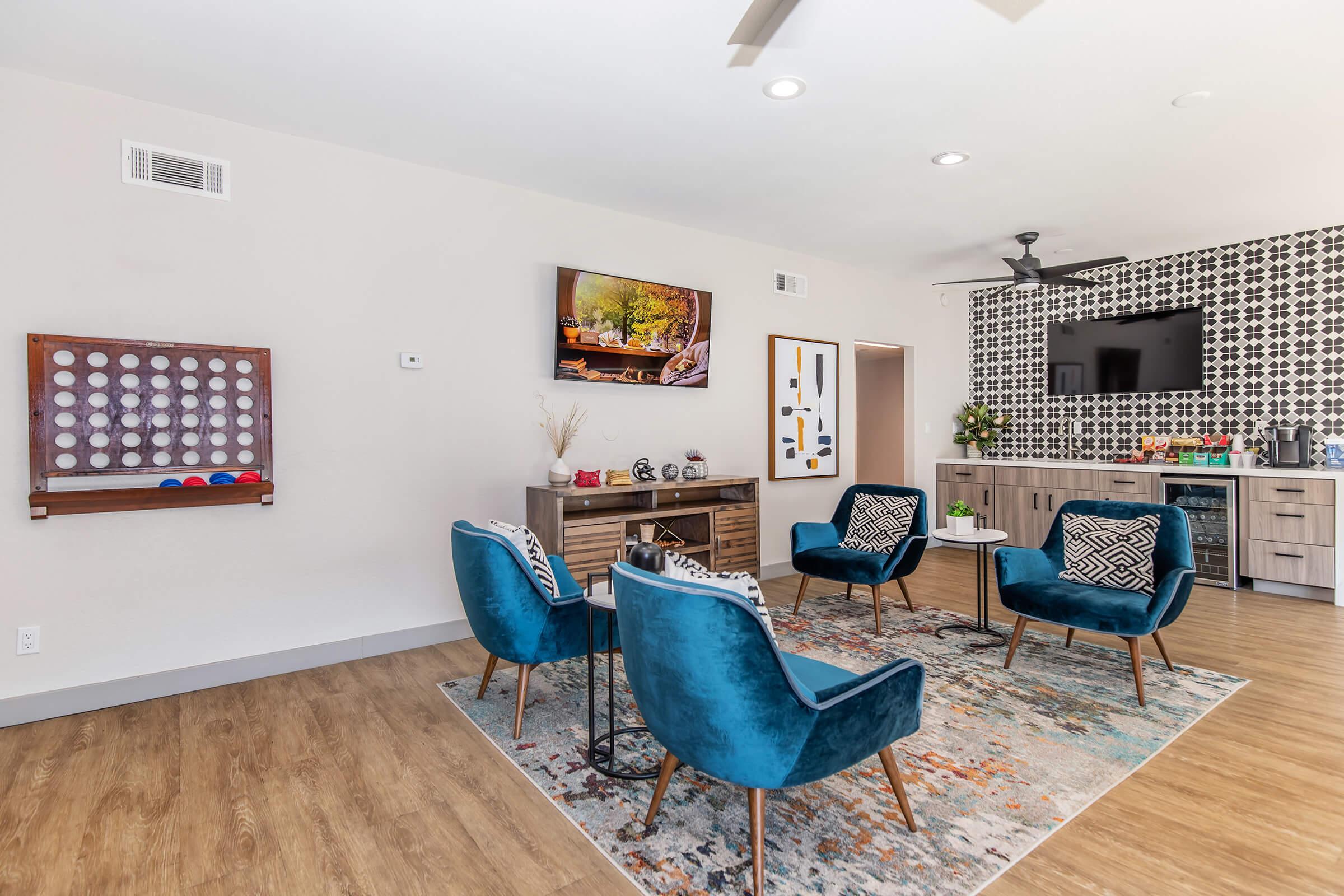 a living room filled with furniture and a blue chair