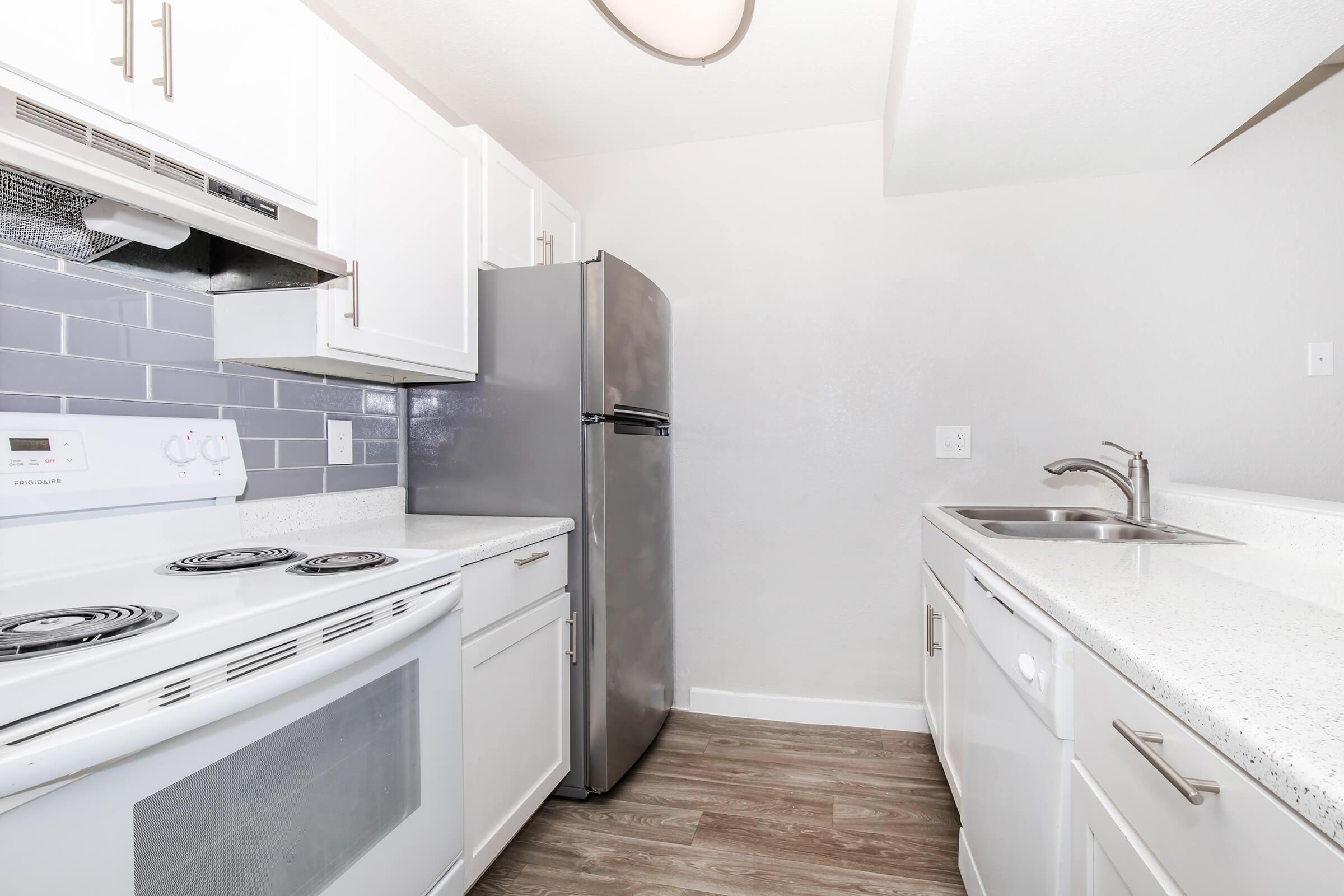 a kitchen with a stove sink and refrigerator