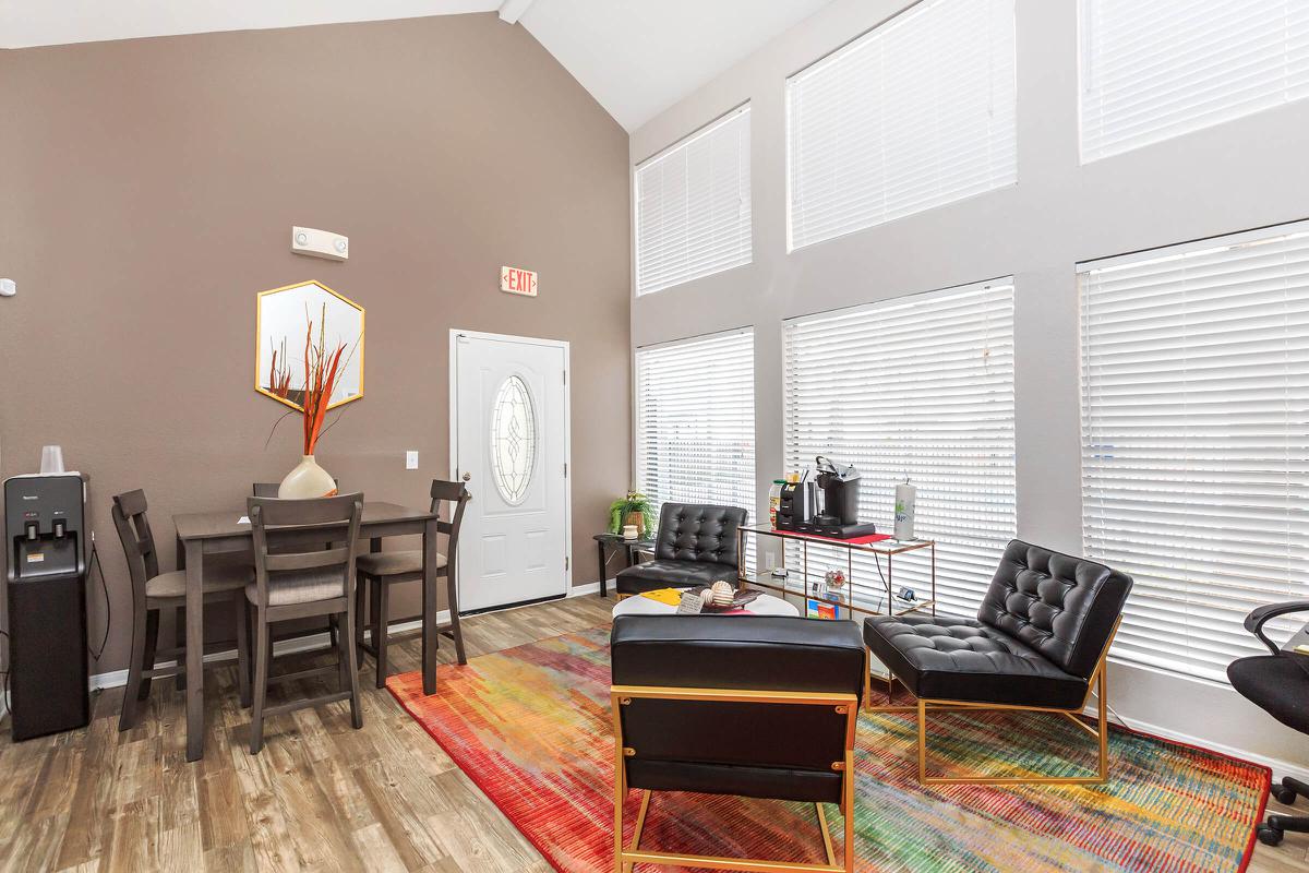 a living room filled with furniture and a large window