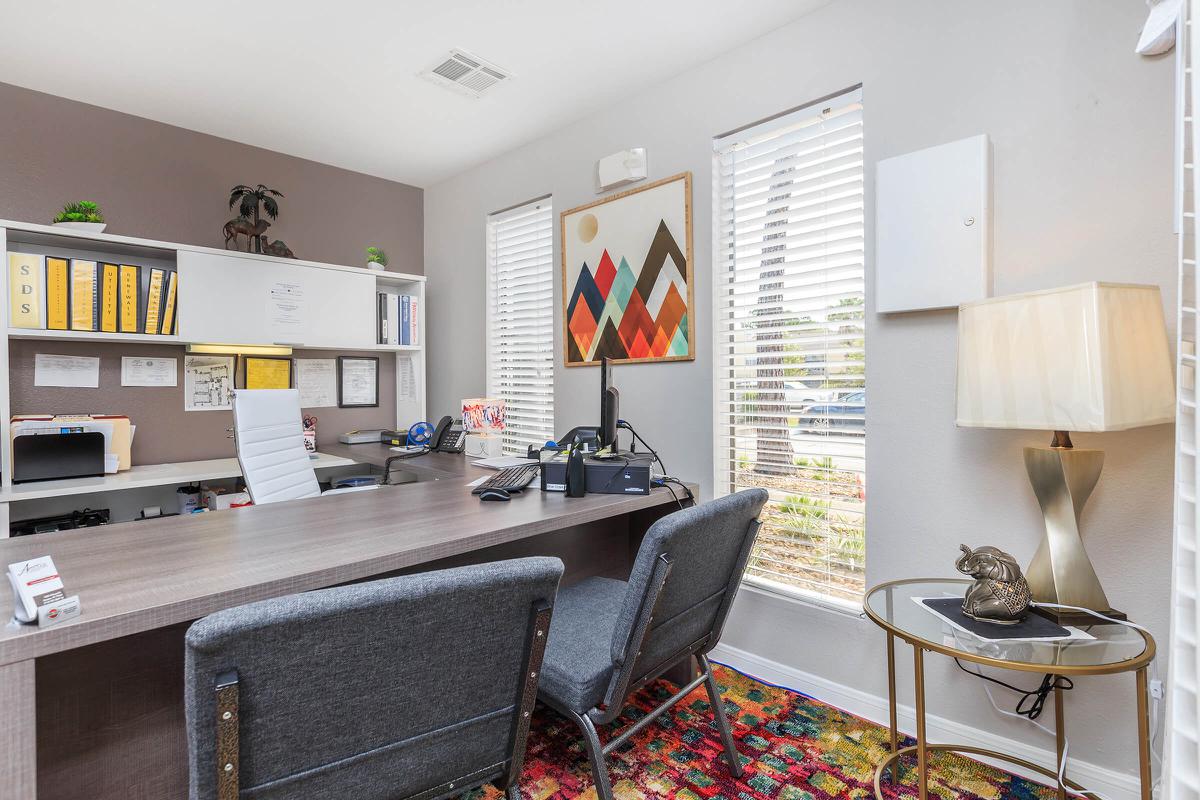 a living room filled with furniture and a large window