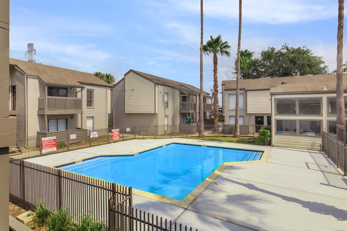 a house with a pool in front of a building