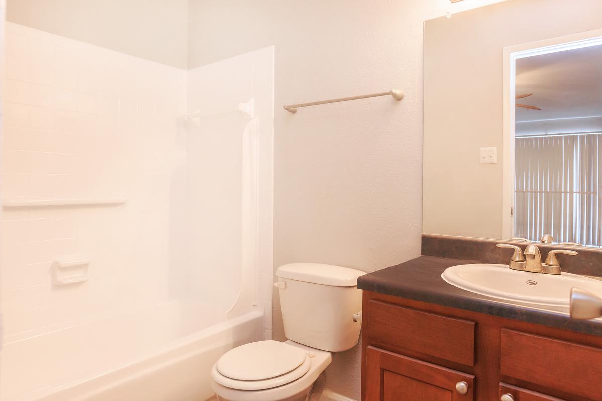 a white tub sitting next to a sink