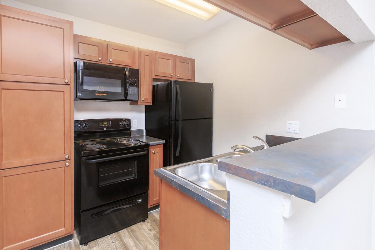 a kitchen with a stove top oven sitting inside of a refrigerator