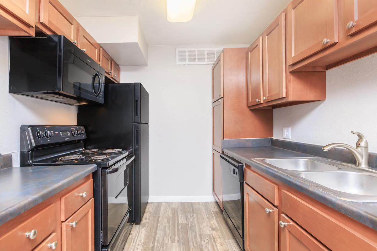 a kitchen with stainless steel appliances and wooden cabinets