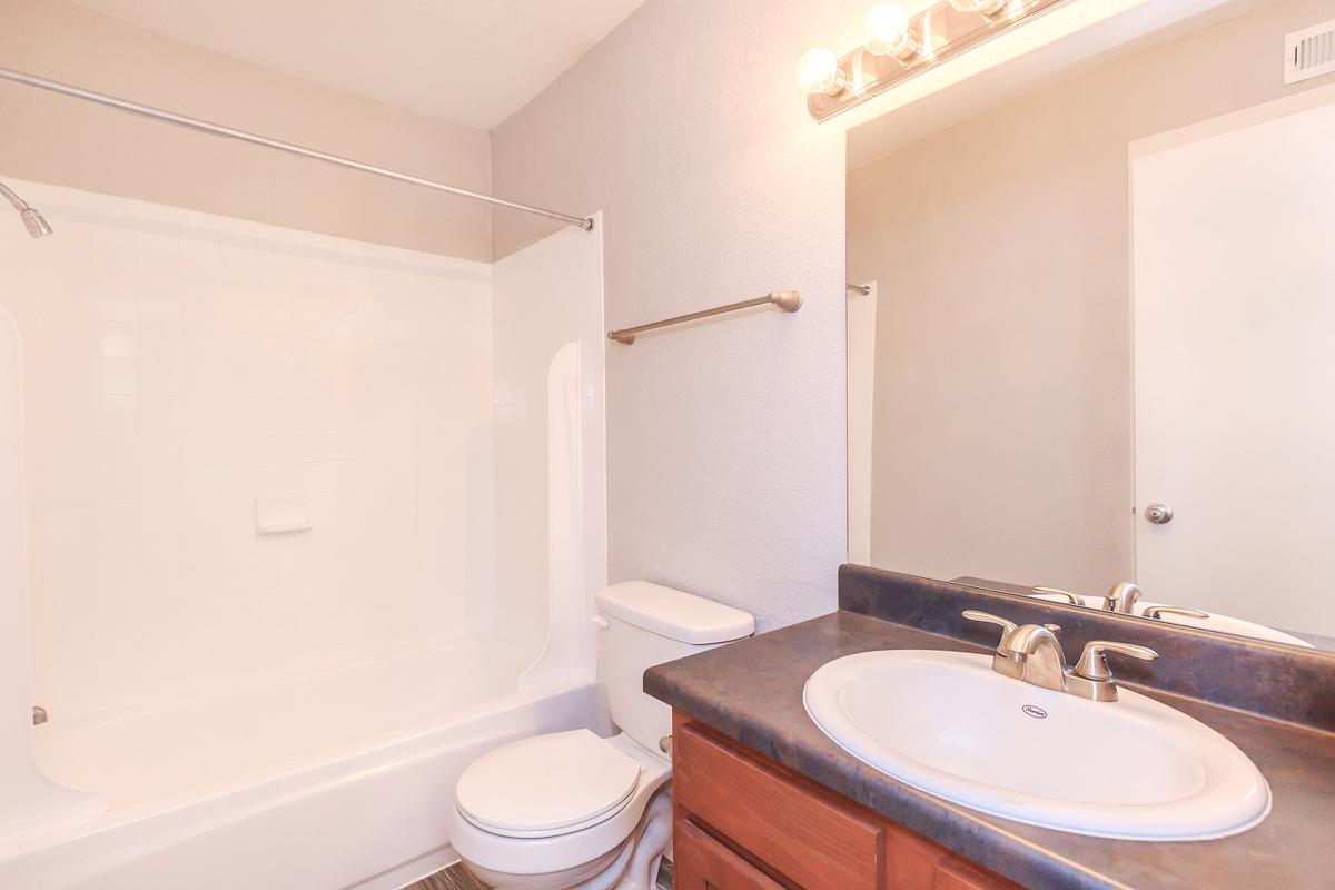 a white tub sitting next to a sink