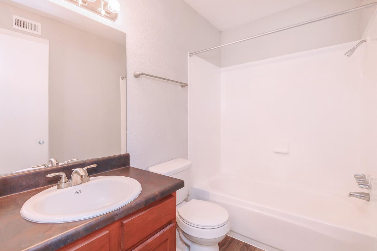 a white sink sitting next to a shower