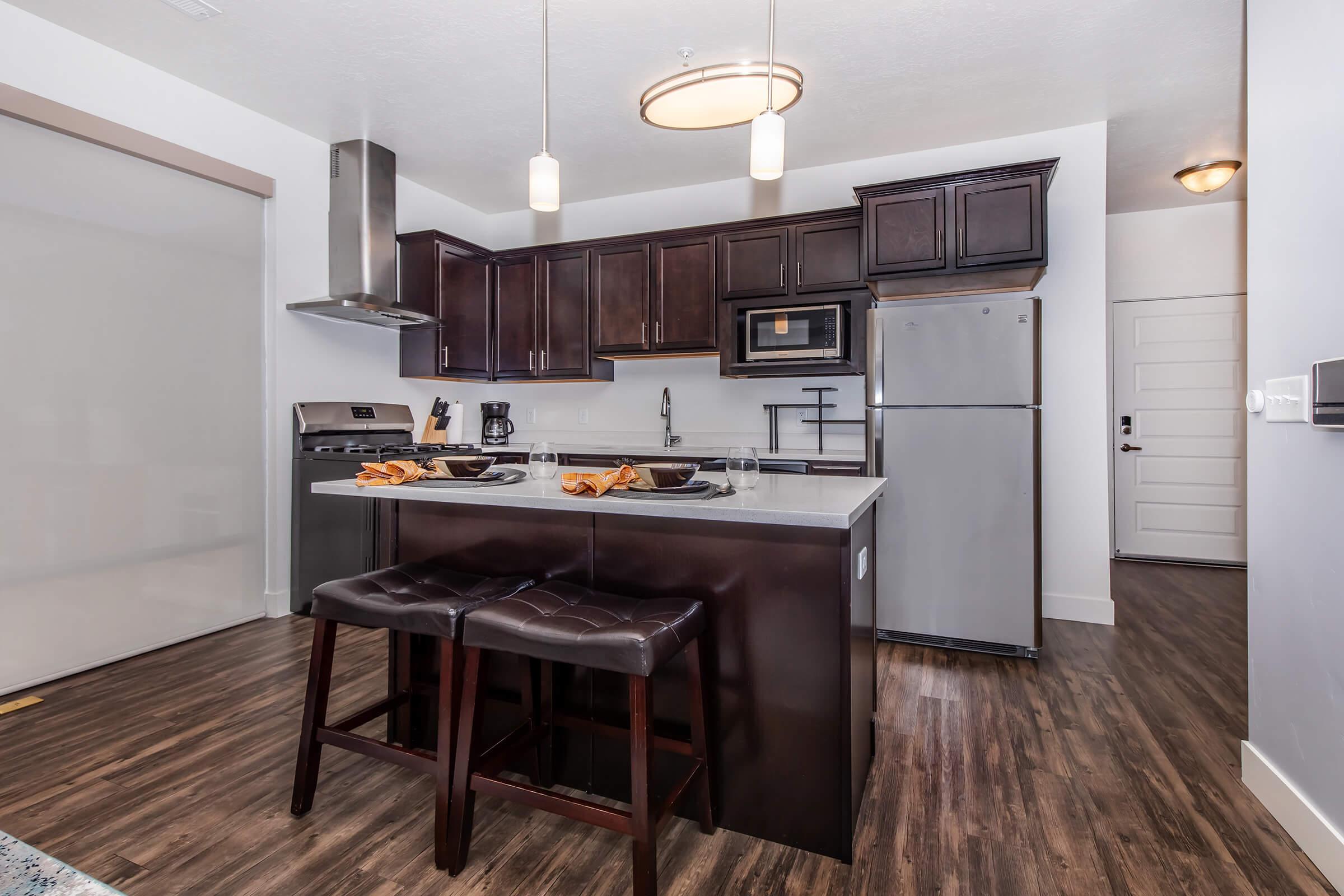 a kitchen with an island in the middle of a room