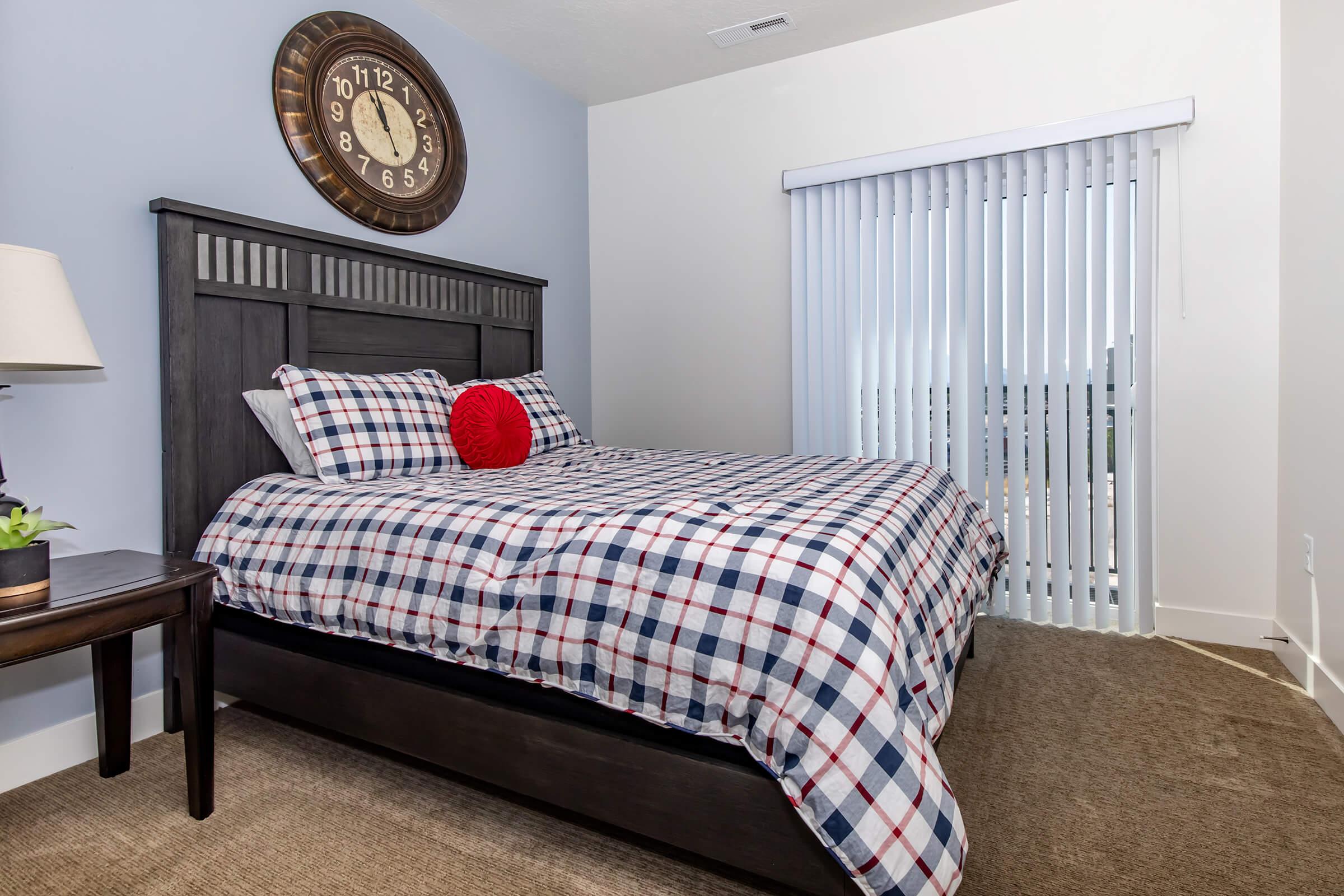 a bedroom with a bed and desk in a room