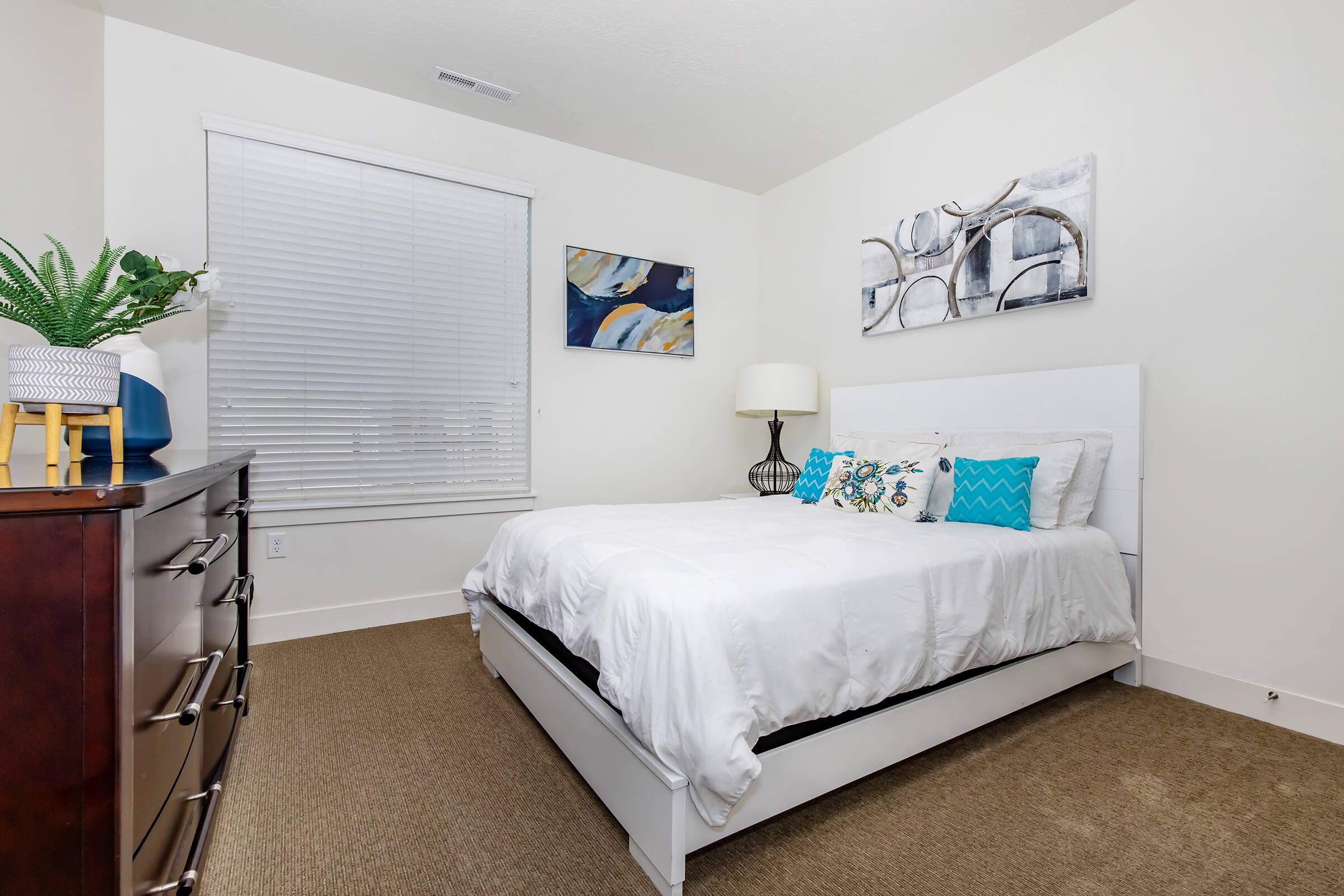 a bedroom with a bed and desk in a room