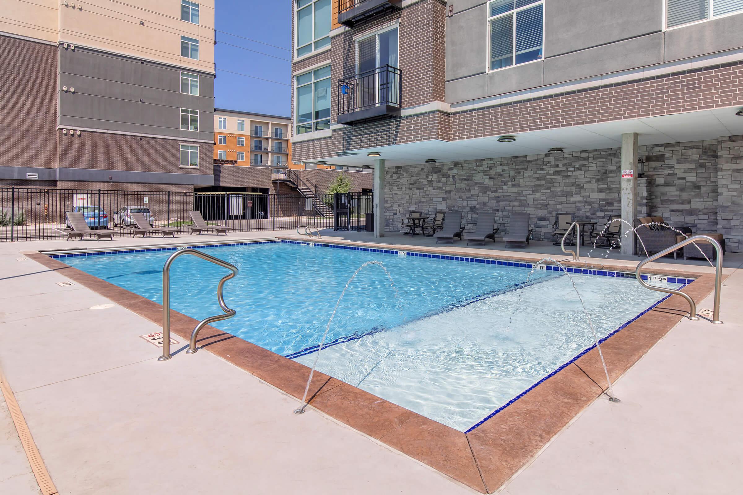 a large brick building with a pool