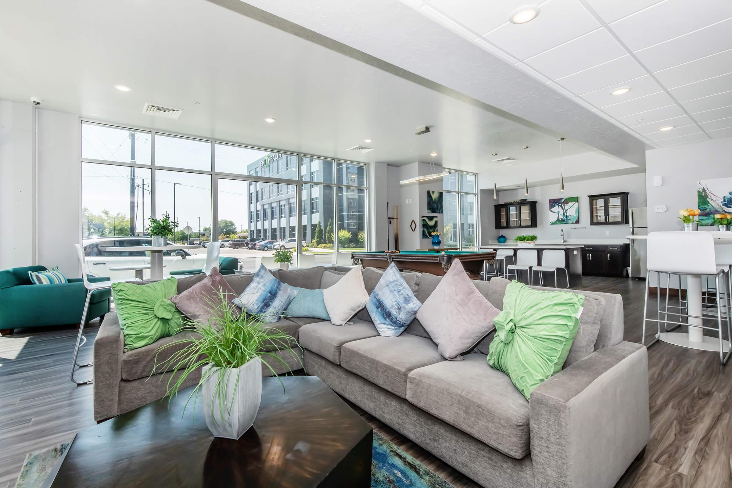 a living room filled with furniture and a large window