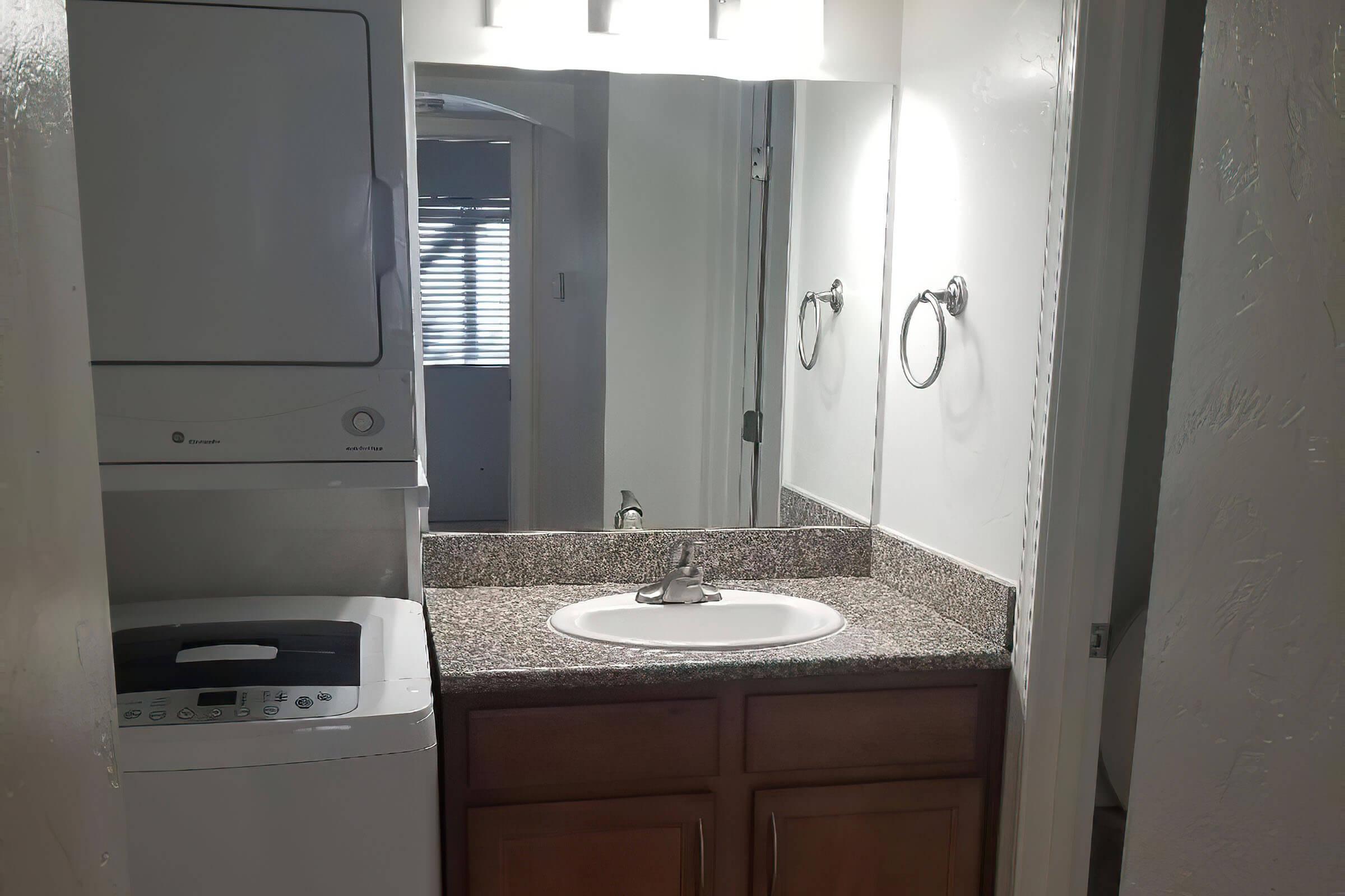 a kitchen with a sink and a mirror