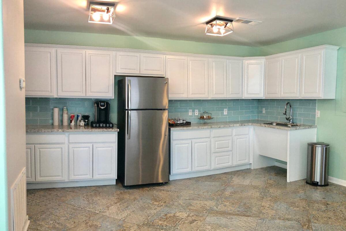 a kitchen with a sink and a refrigerator