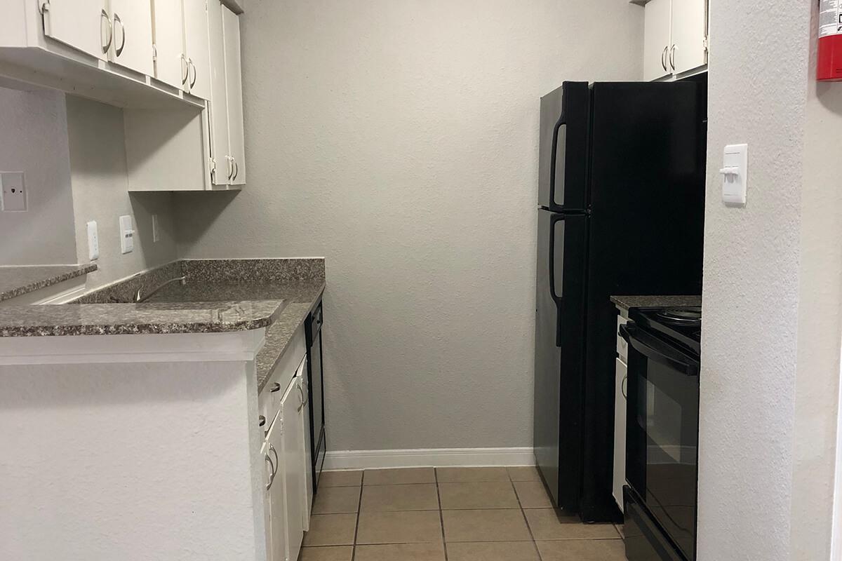 a kitchen with a sink and a refrigerator