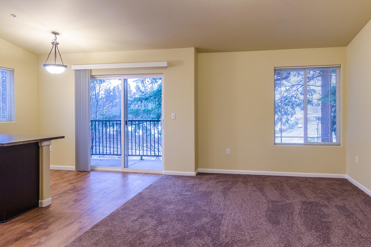 a view of a living room filled with furniture and a large window