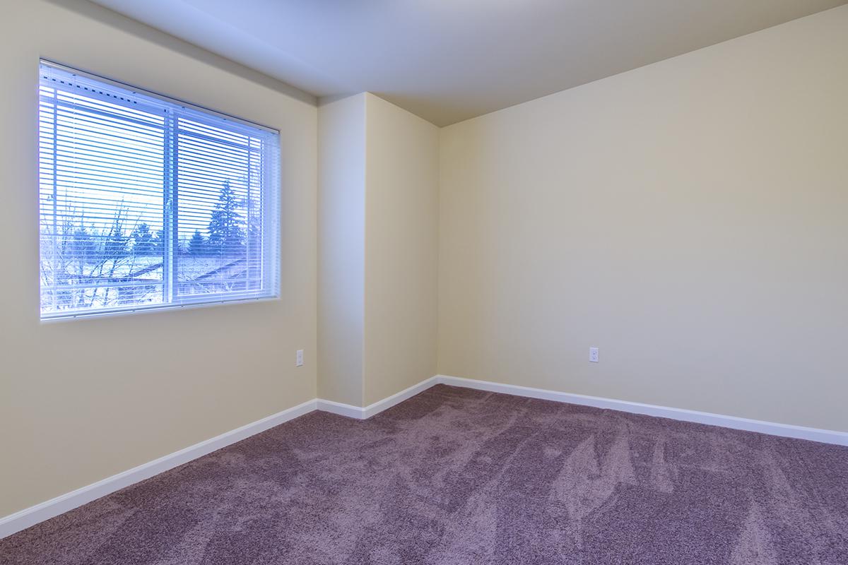 a bedroom with a large window