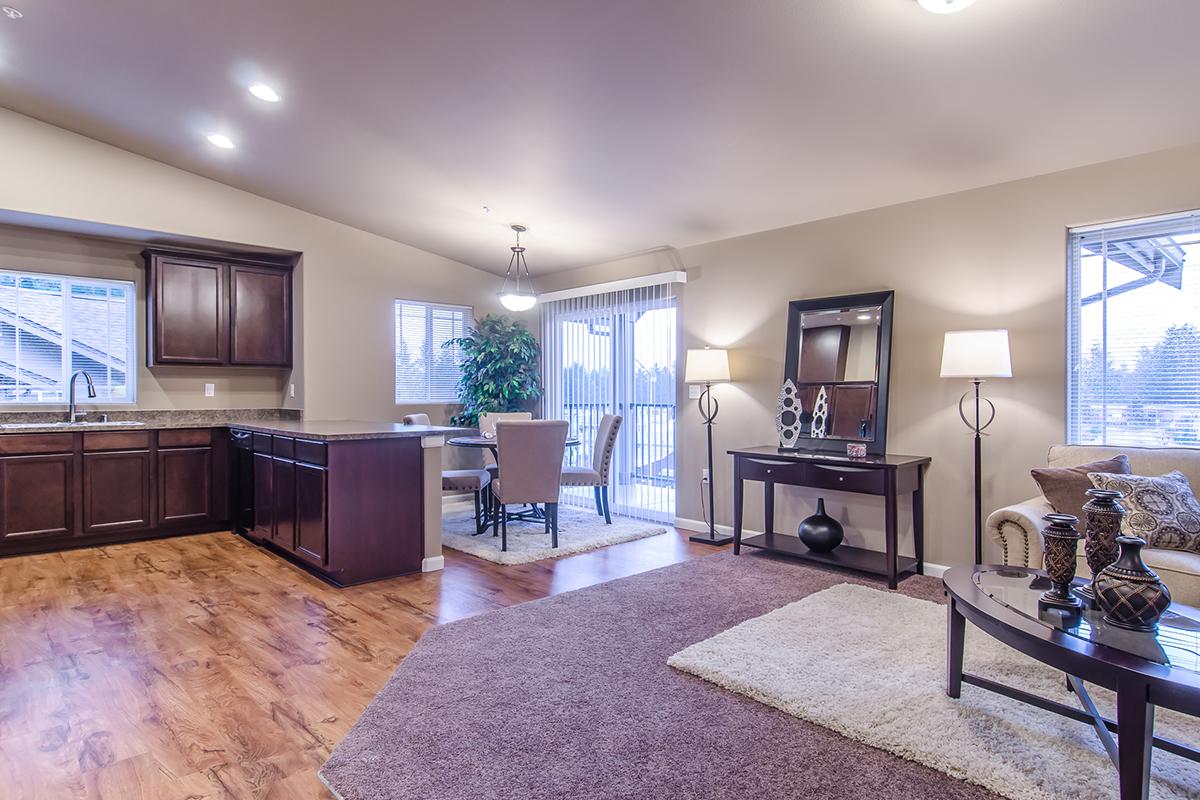 a living room filled with furniture and a flat screen tv