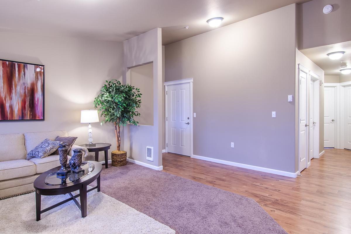a living room filled with furniture and a large window