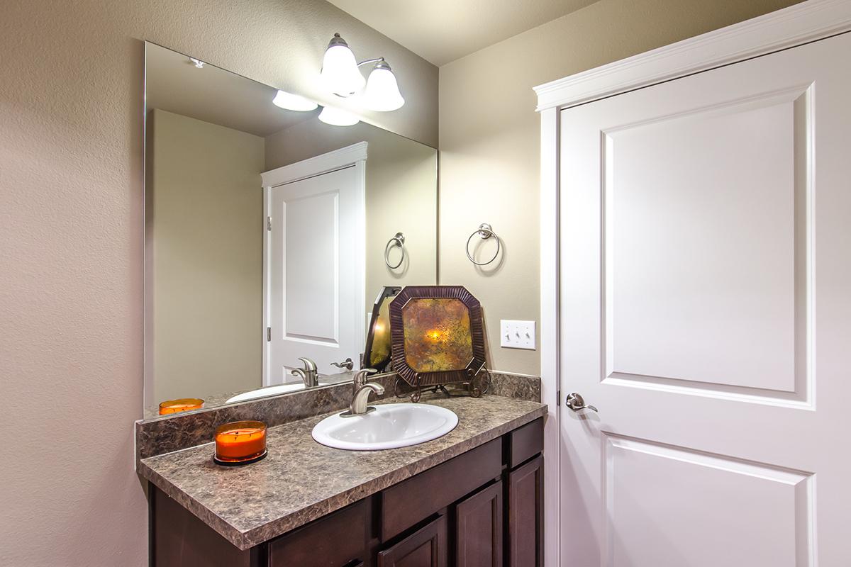 a kitchen with a sink and a mirror