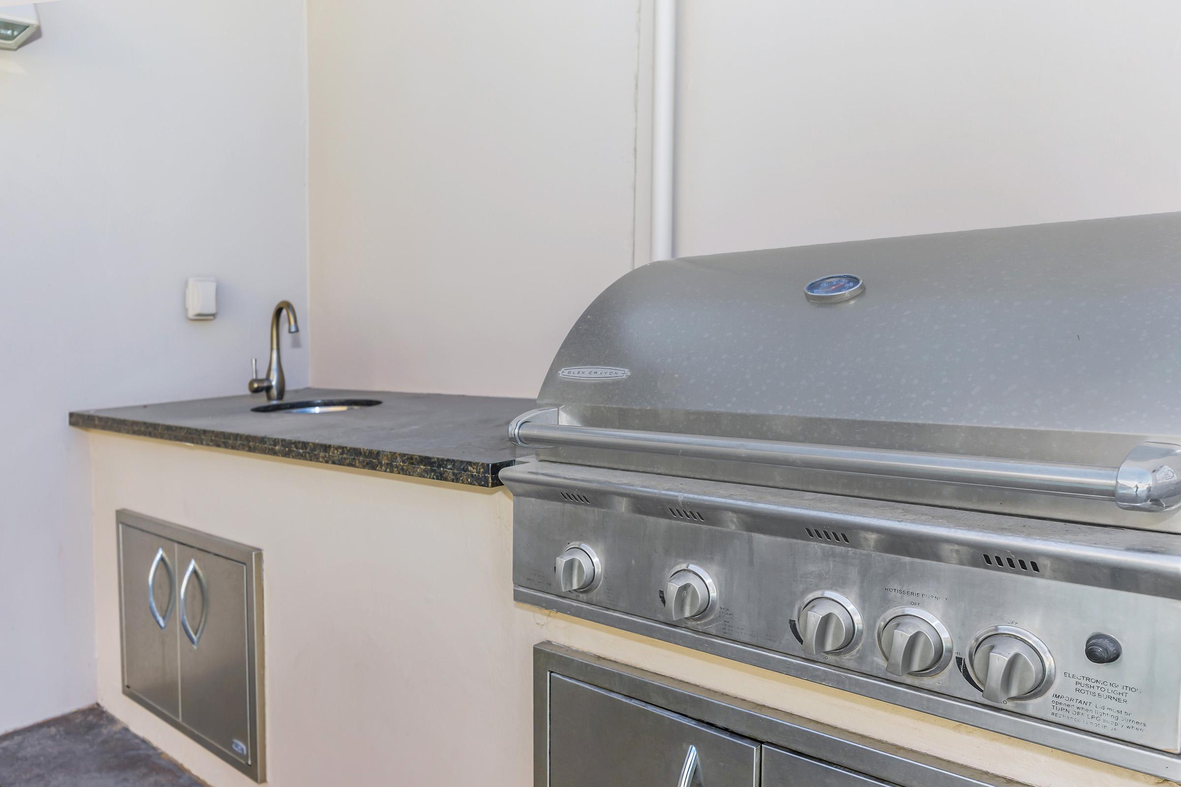 a stove top oven sitting inside of a kitchen