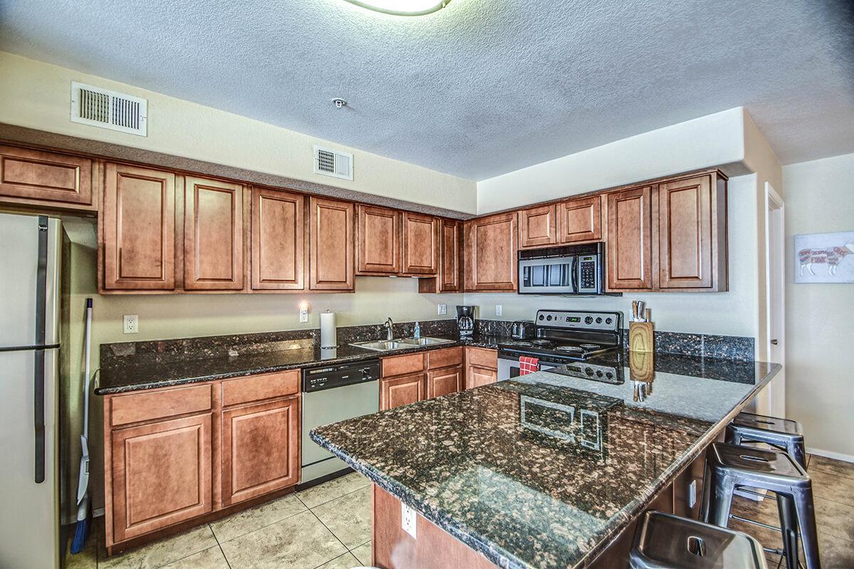 a modern kitchen with stainless steel appliances and wooden cabinets