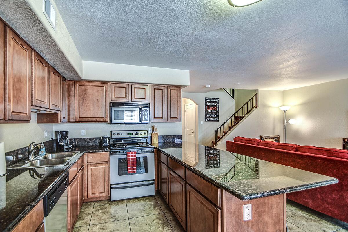 a kitchen with stainless steel appliances and wooden cabinets