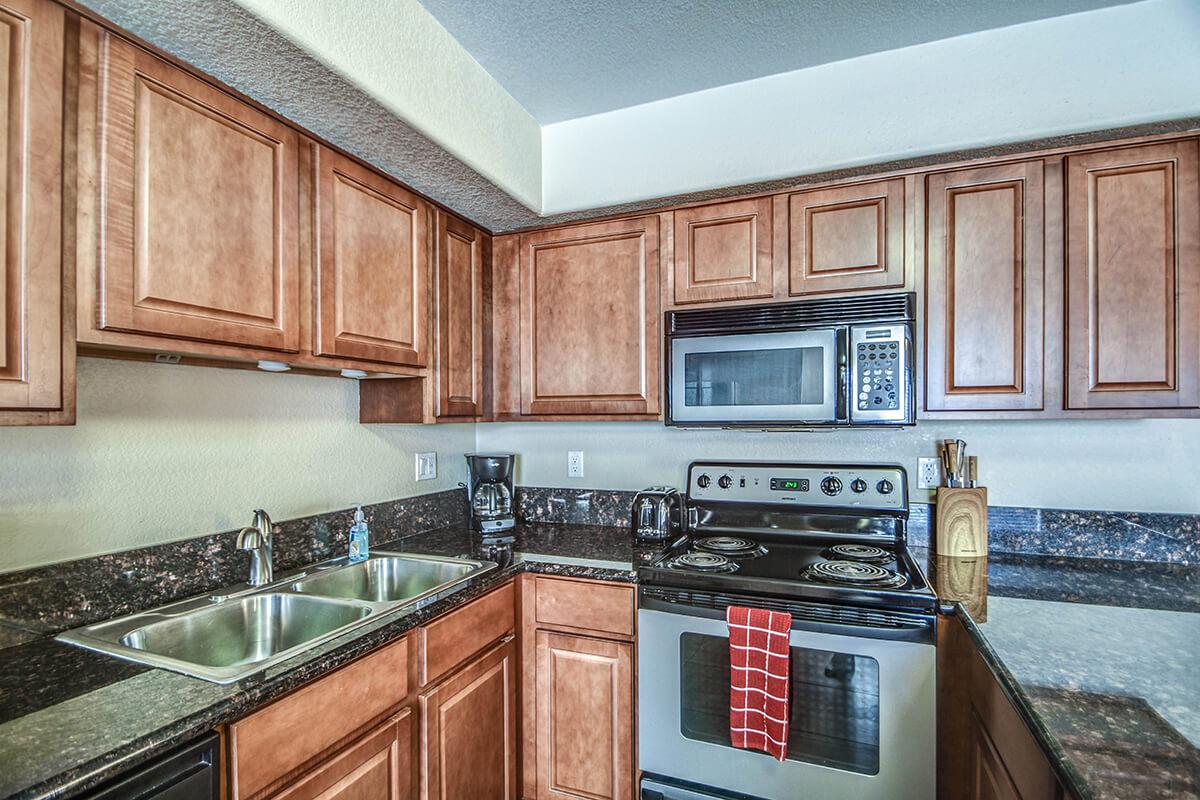 a kitchen with stainless steel appliances and wooden cabinets