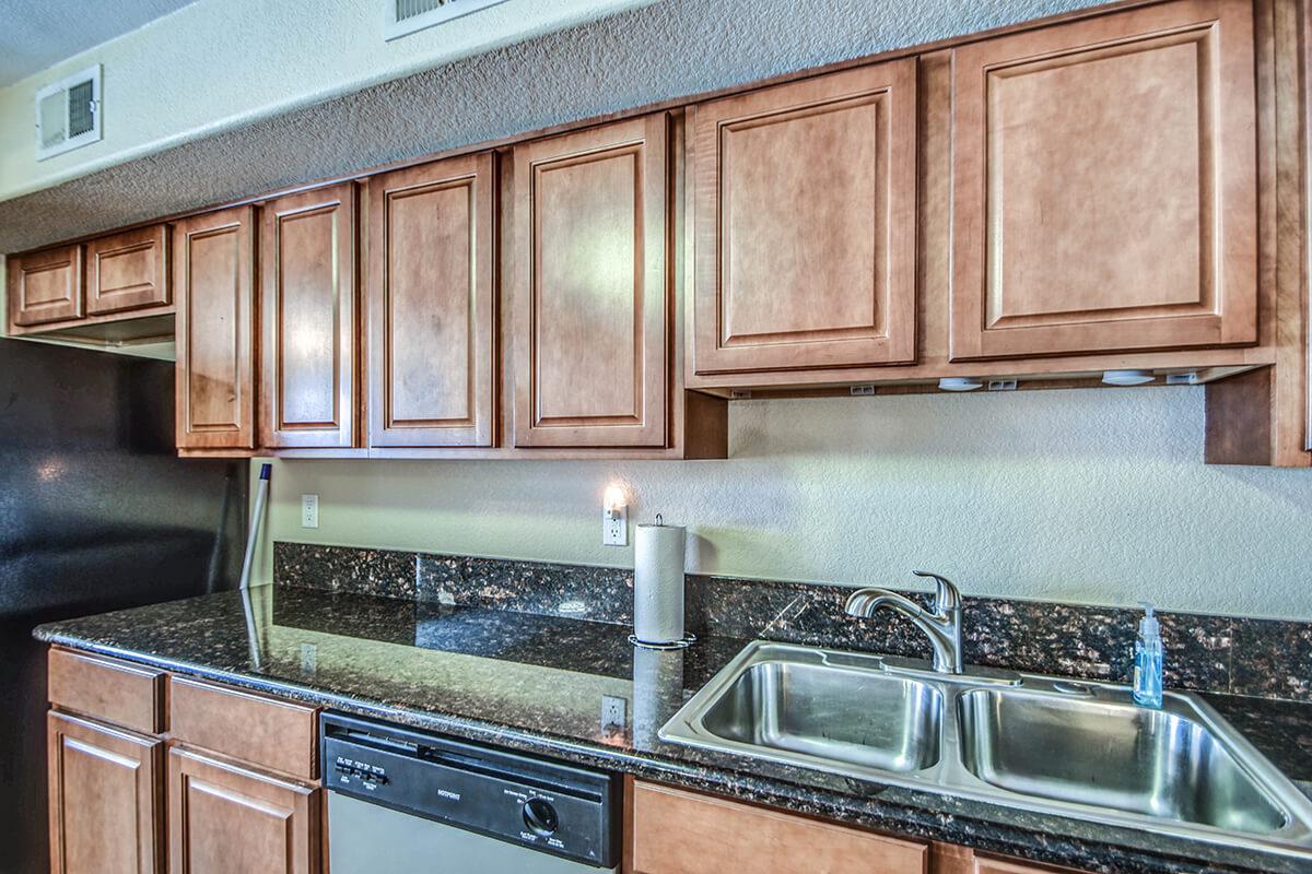 a kitchen with stainless steel appliances and wooden cabinets