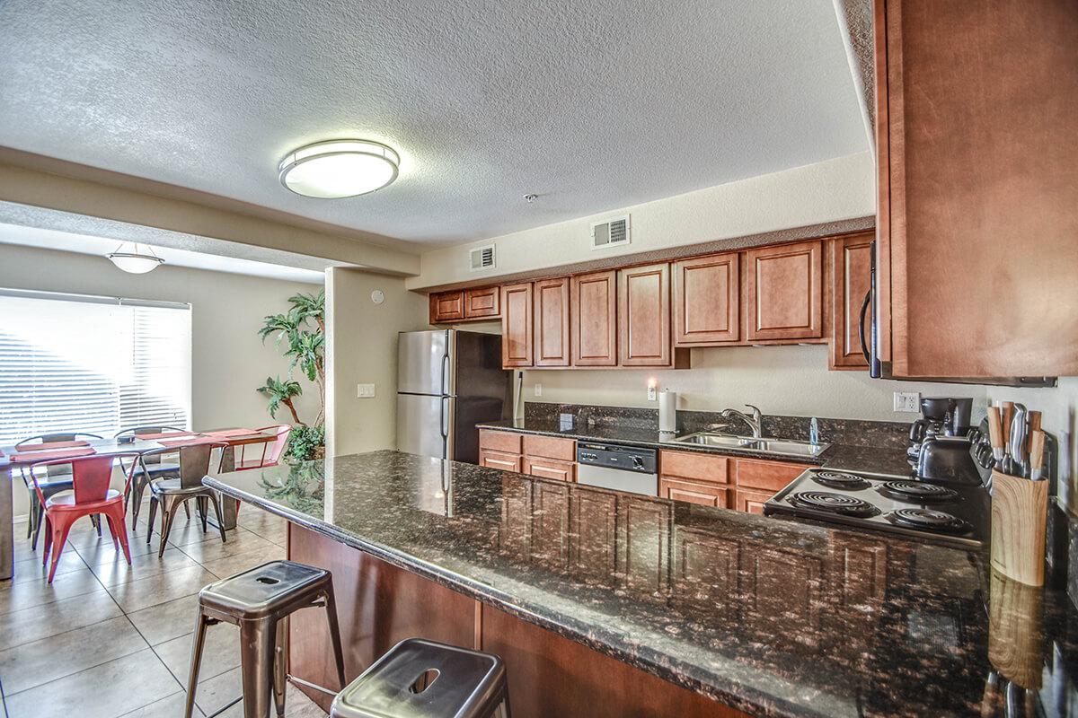 a large kitchen with stainless steel appliances and wooden cabinets