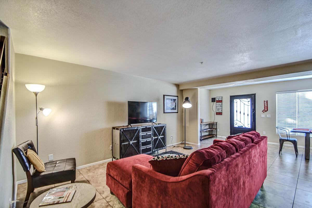 a living room filled with furniture and a flat screen tv