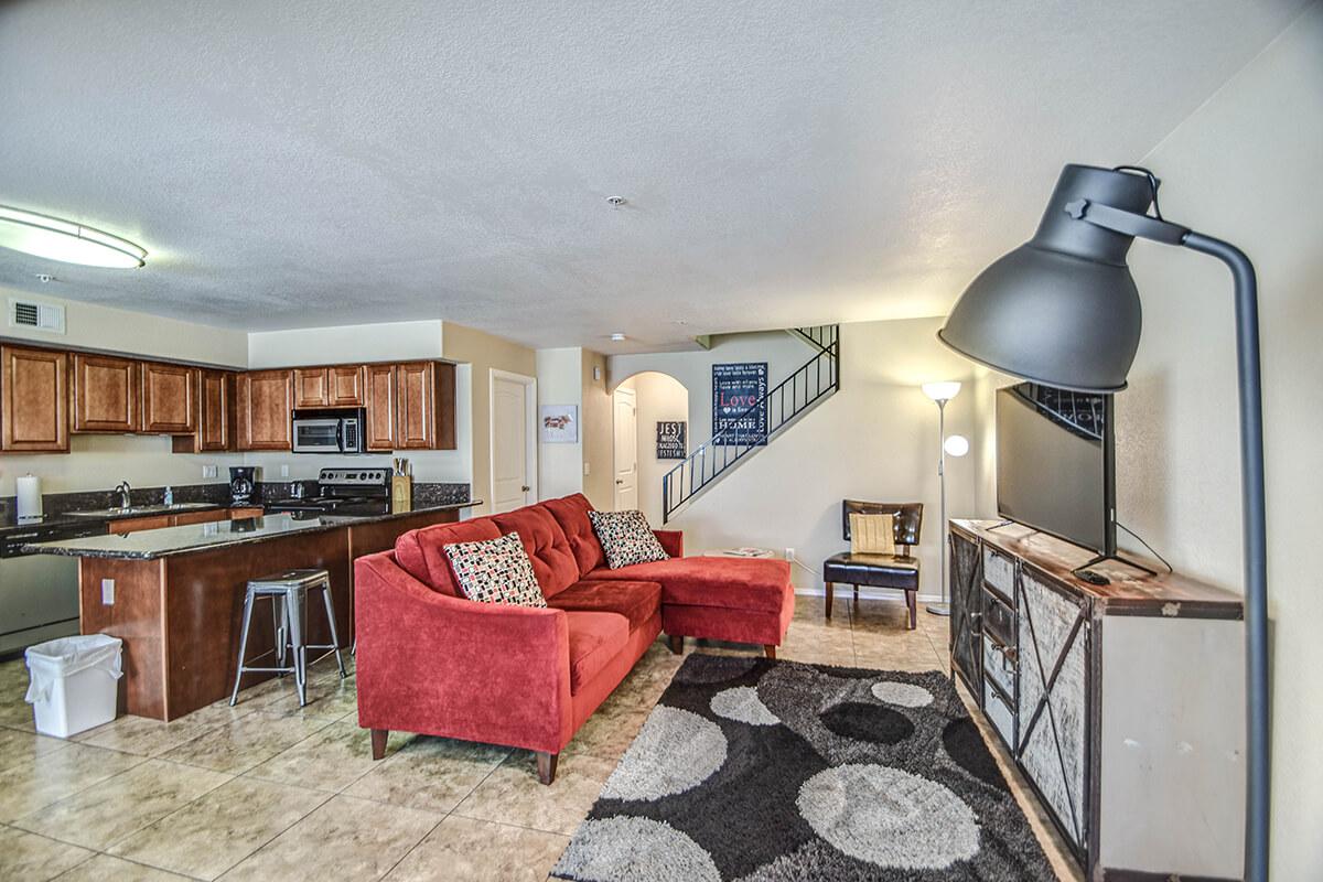 a living room filled with furniture and a tv