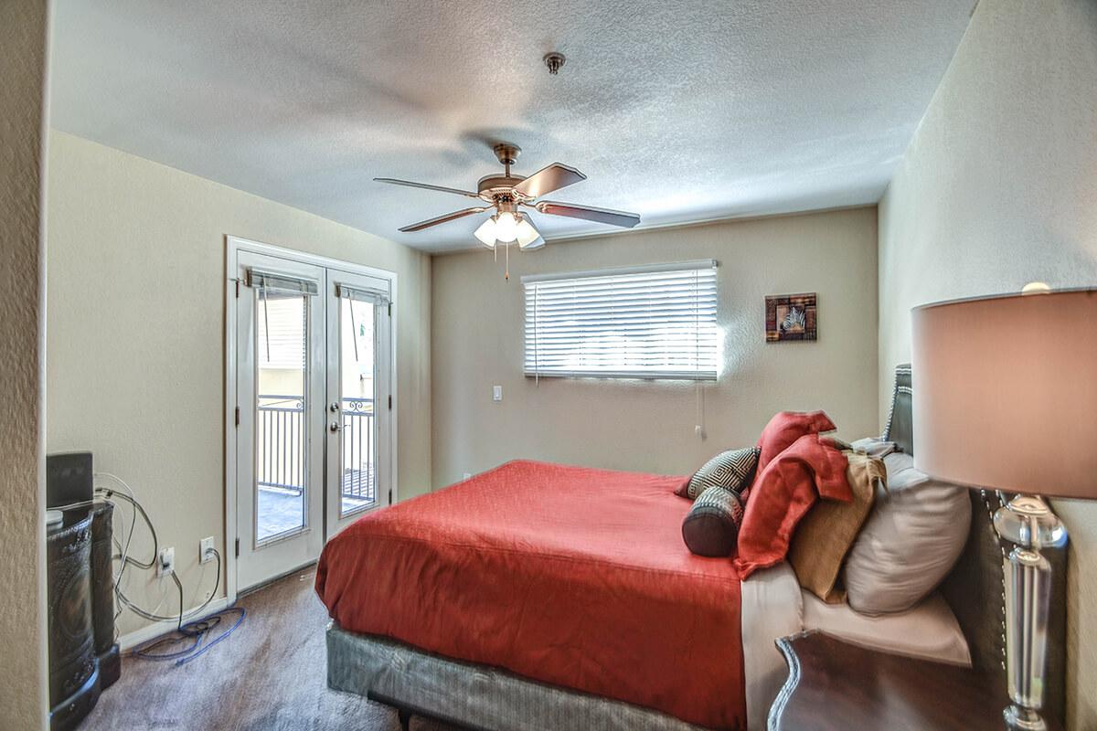 a bedroom with a large red chair in a room