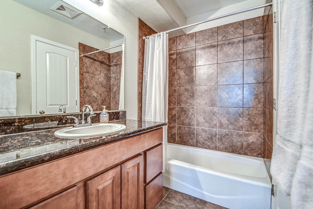 a large white tub sitting next to a sink