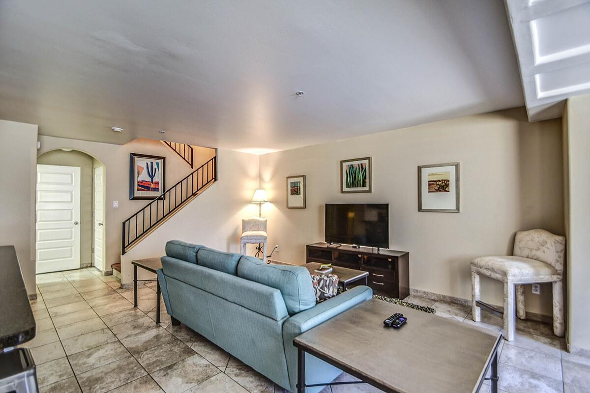 a living room filled with furniture and a tv