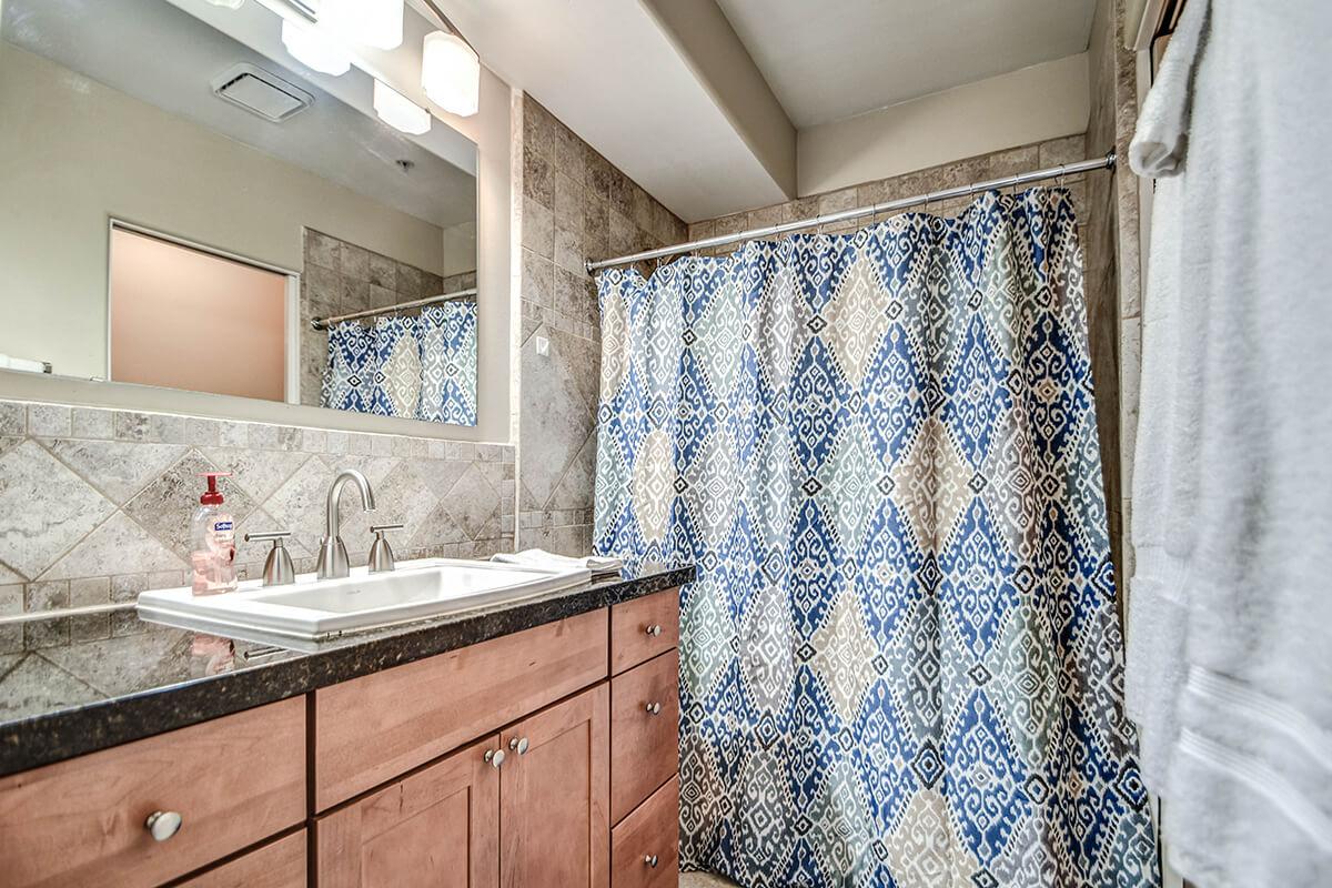 a shower curtain next to a sink