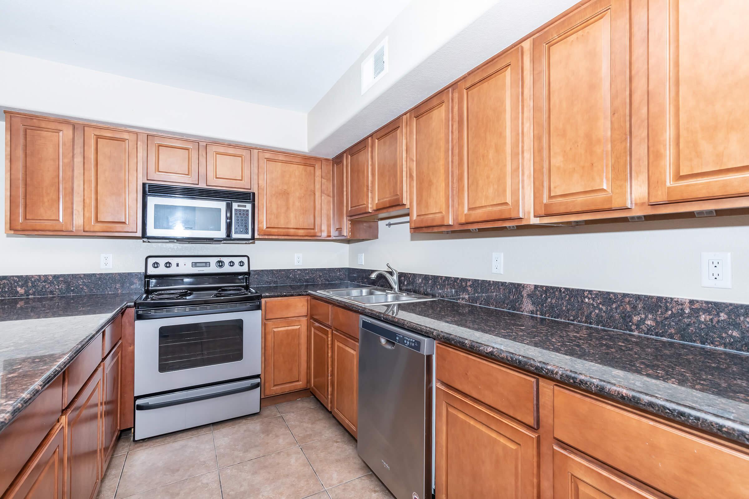 a kitchen with stainless steel appliances and wooden cabinets