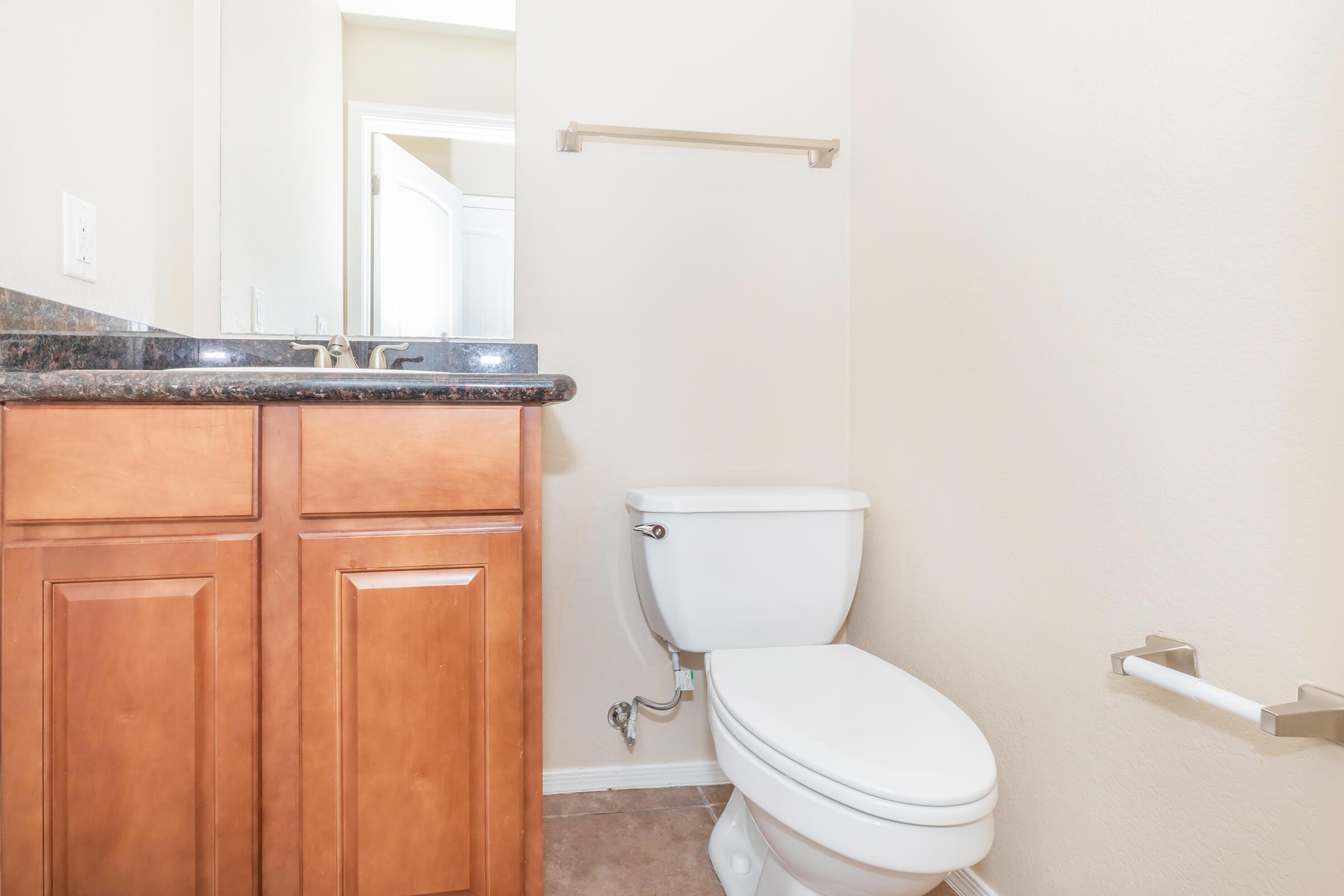 a white sink sitting next to a shower