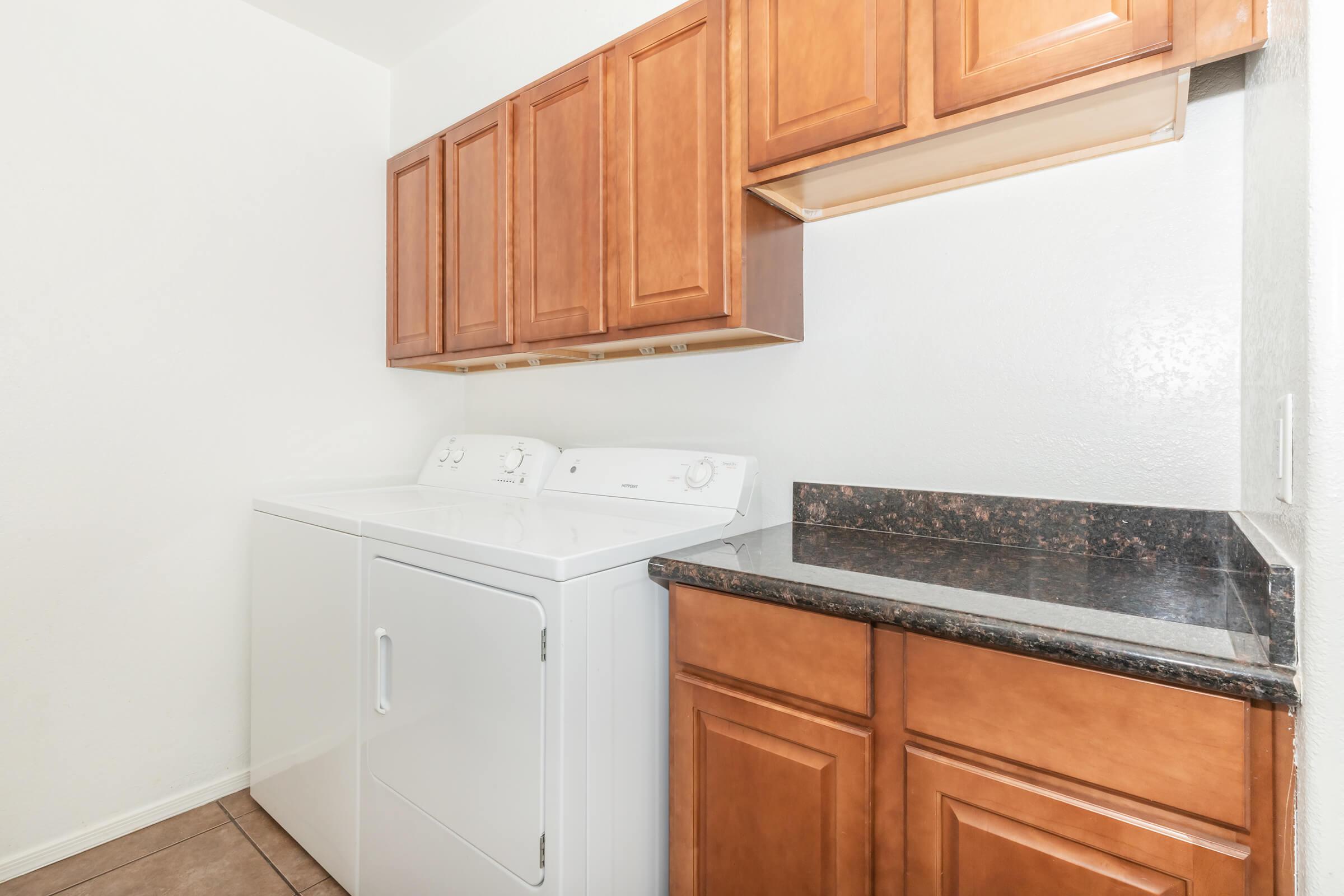 a kitchen with white appliances and wooden cabinets