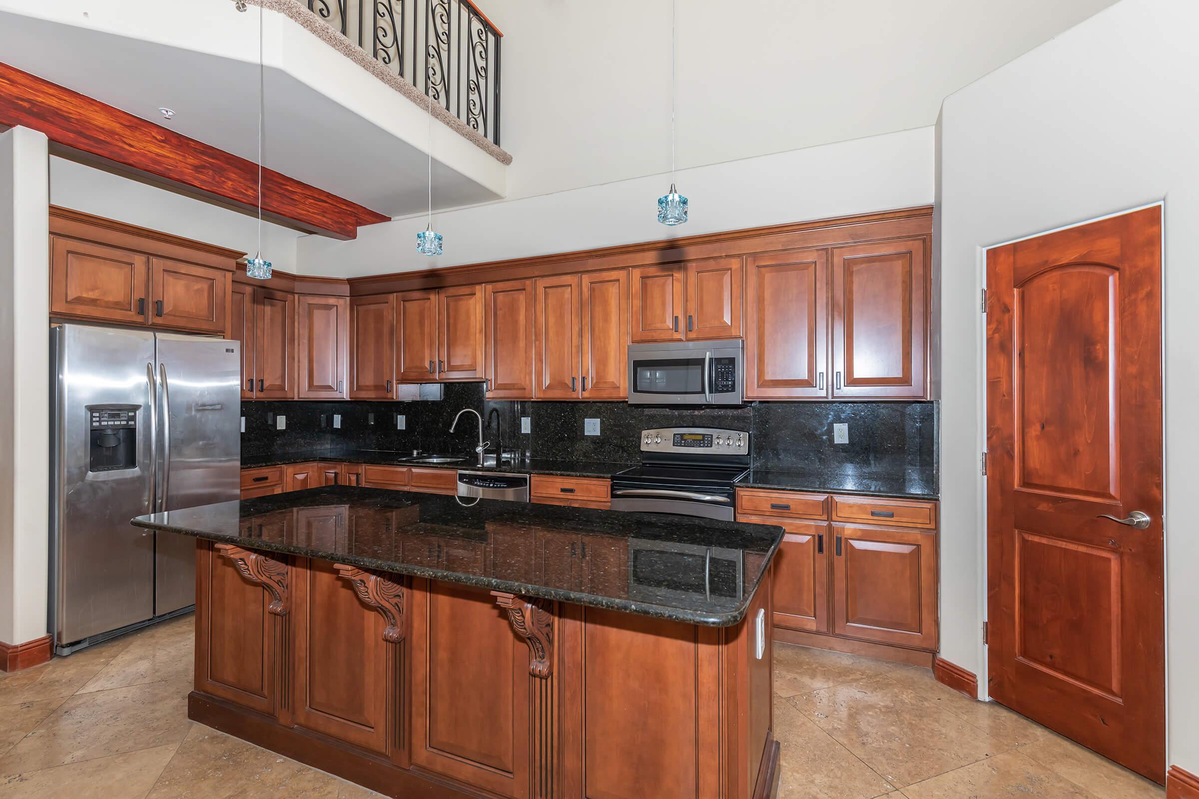 a kitchen with stainless steel appliances and wooden cabinets