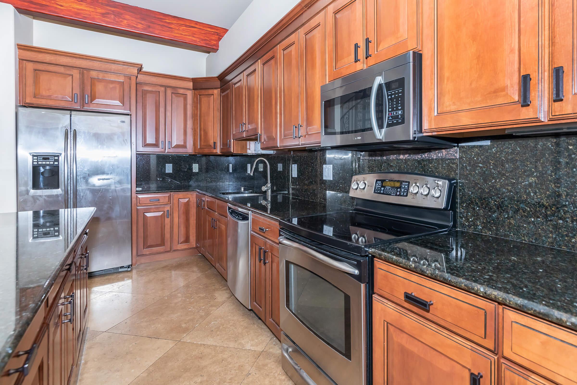 a kitchen with stainless steel appliances and wooden cabinets