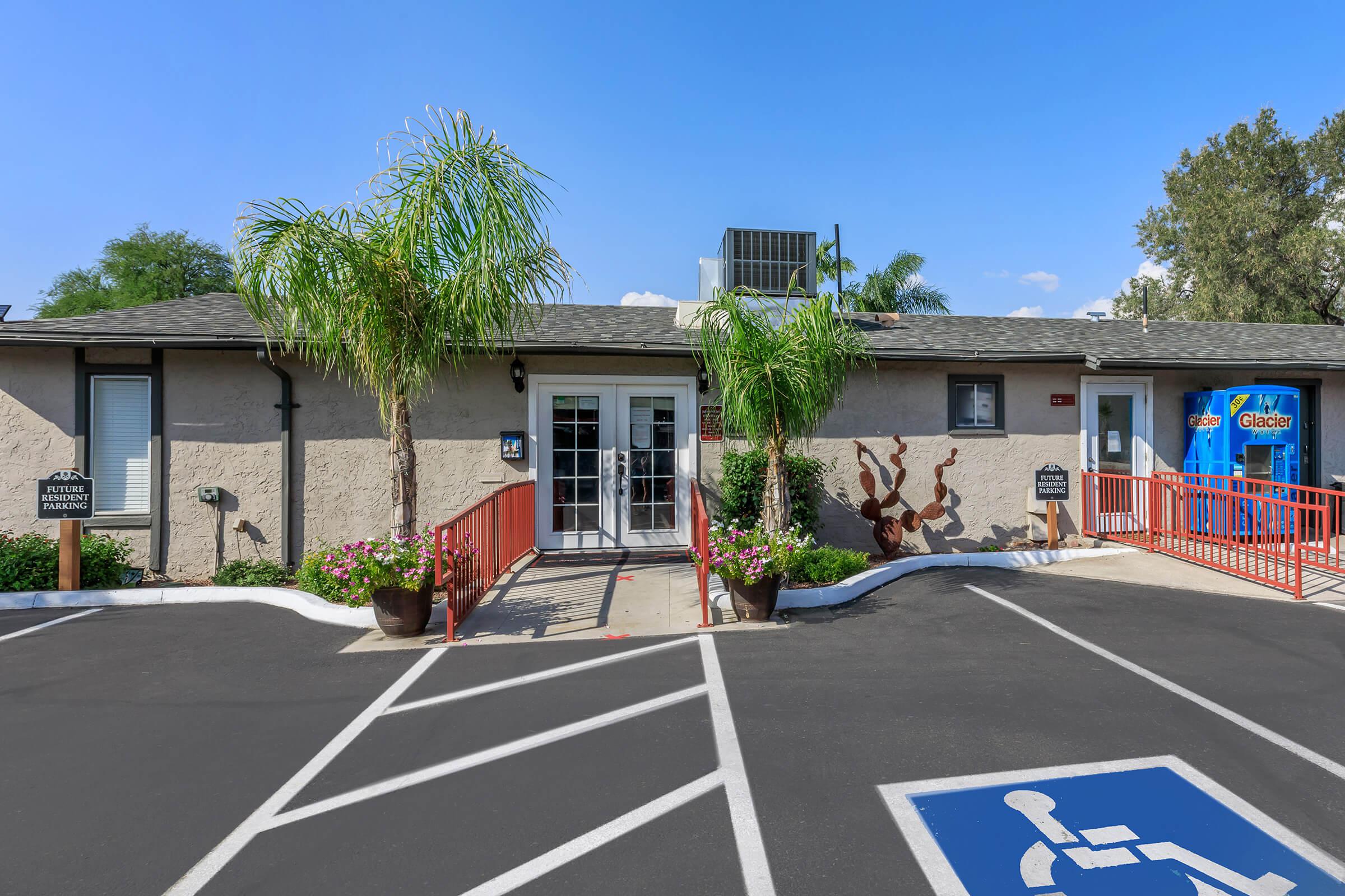 an empty parking lot in front of a house