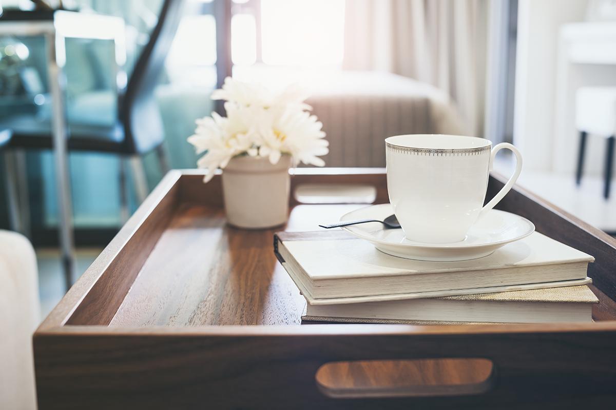 a cup of coffee sitting on top of a wooden table