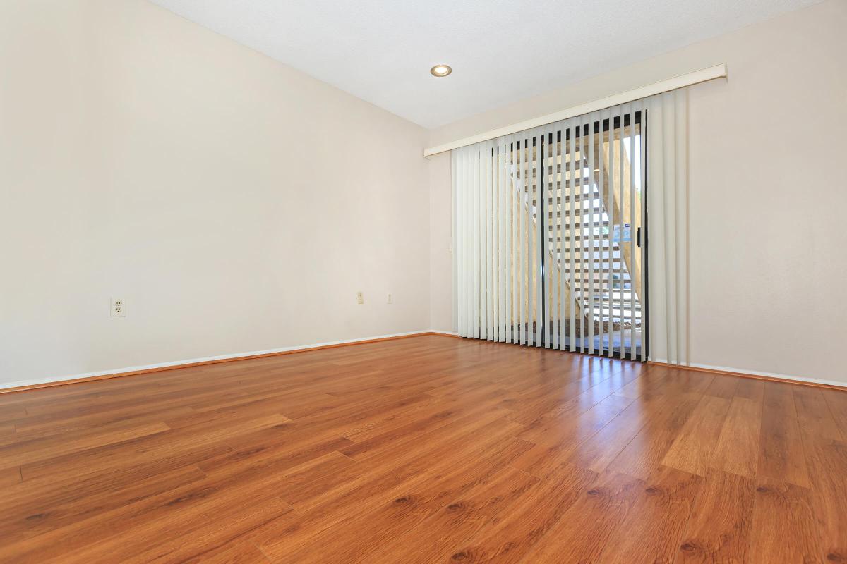 a large empty room with a wood floor